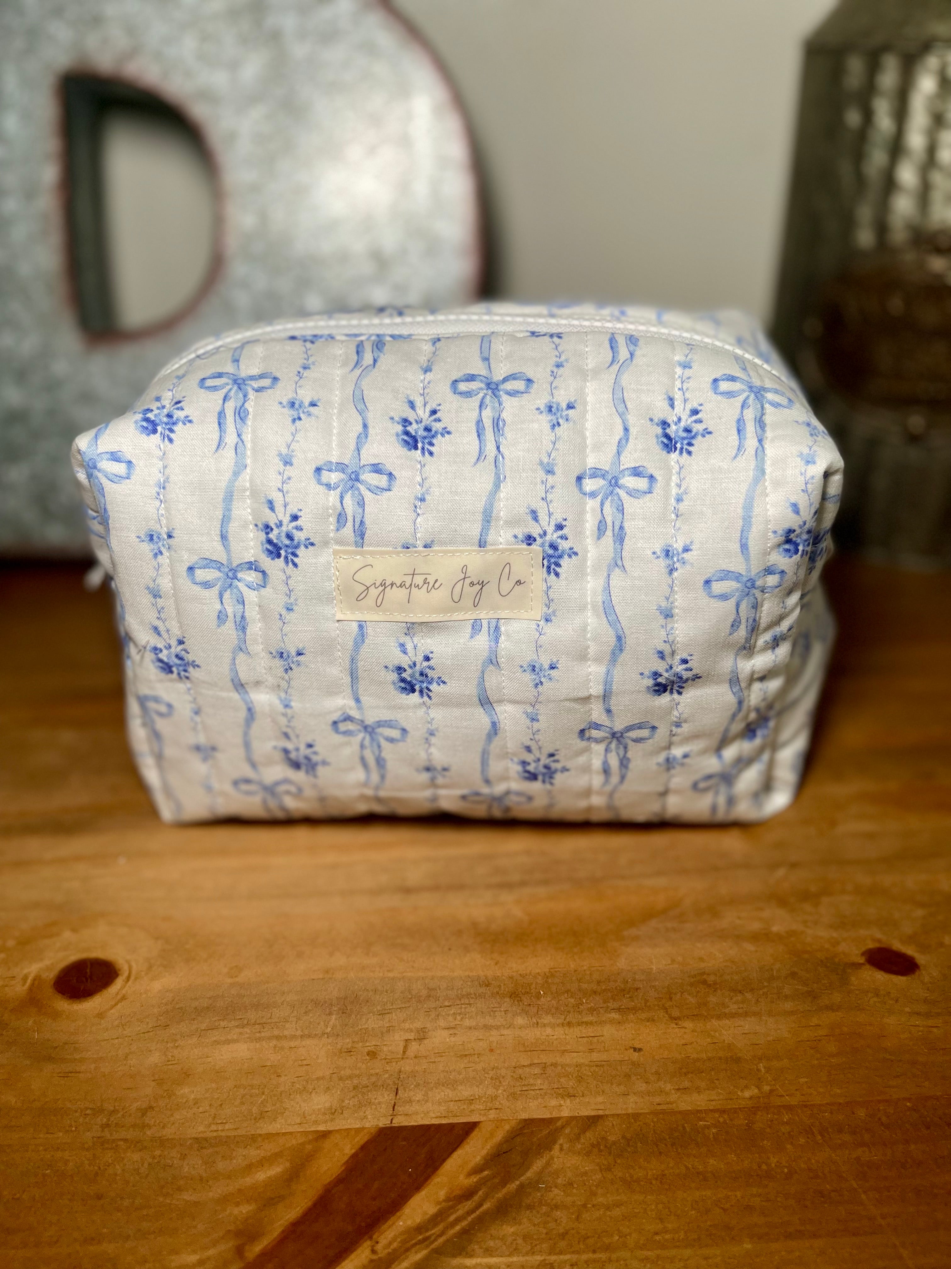 Blue Ribbon Bloom Quilted Makeup Bag | Signature Pouch