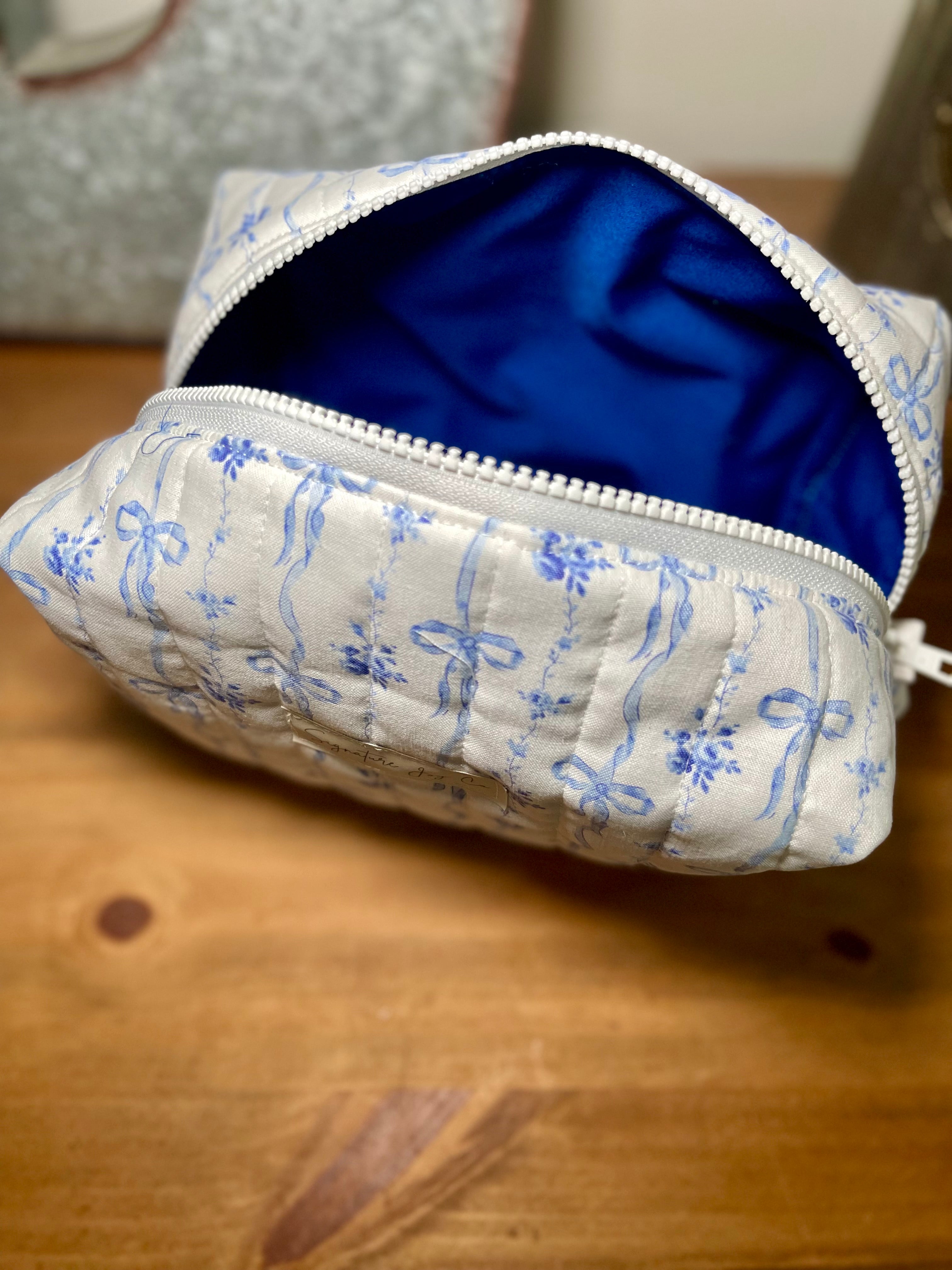 Blue Ribbon Bloom Quilted Makeup Bag | Signature Pouch
